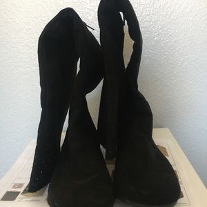 Thigh high boots with zipper.